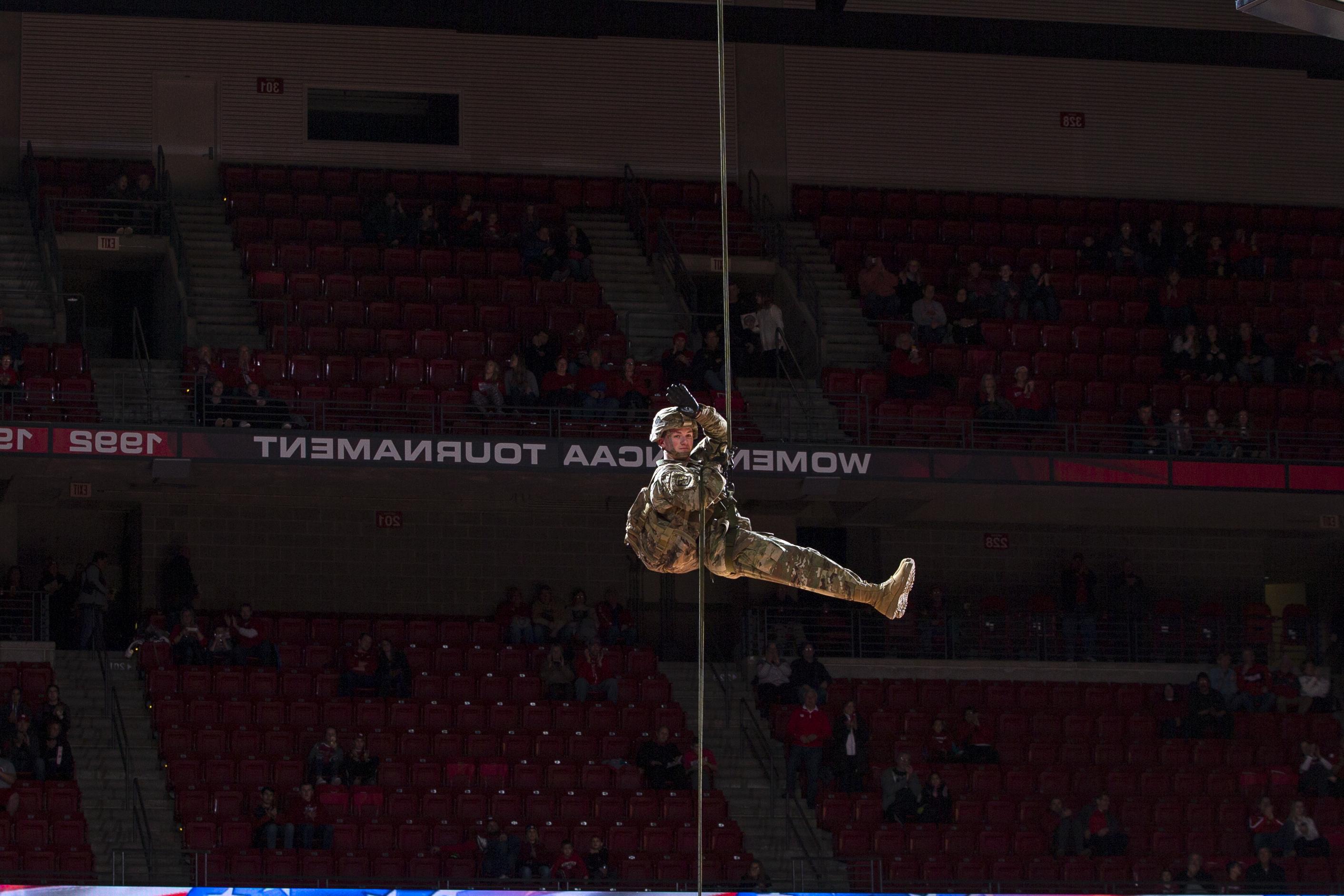 student in uniform rappeling down in UW-Madison building